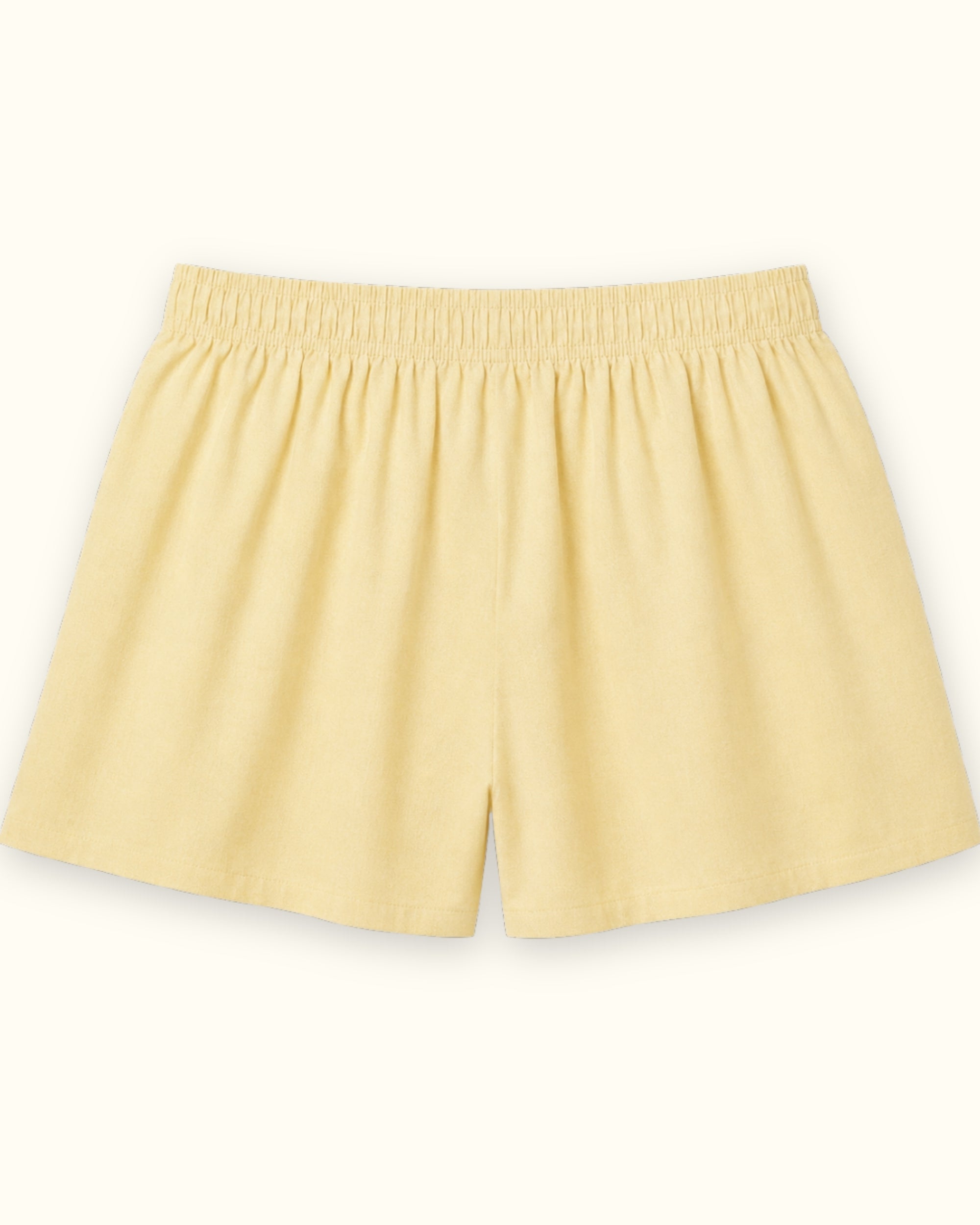 Short boxer en coton jaune clair, vue de dos, montrant la ceinture et la forme de la jambe