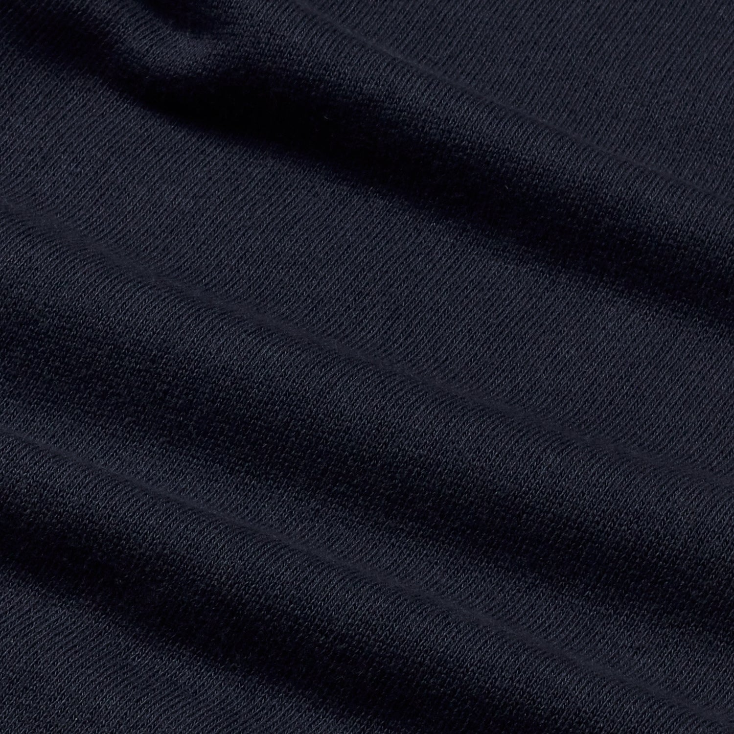 Close-up of navy blue sweatshirt's fabric showing fine texture detail.