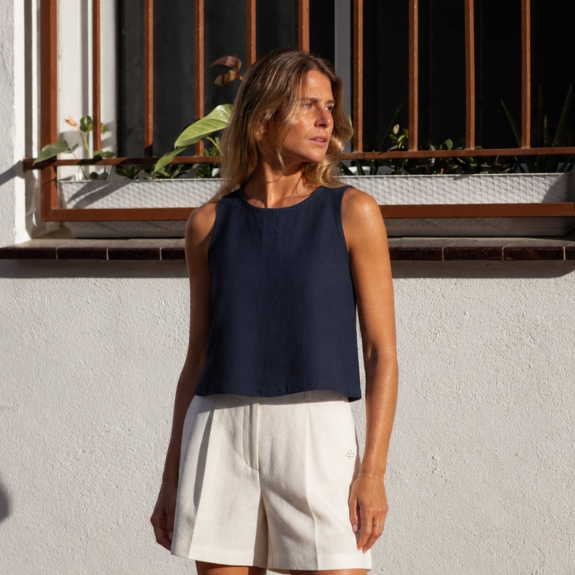 Sleeveless Linen Top in Navy Blue, lifestyle view 1, showing neckline and sleeveless shape
