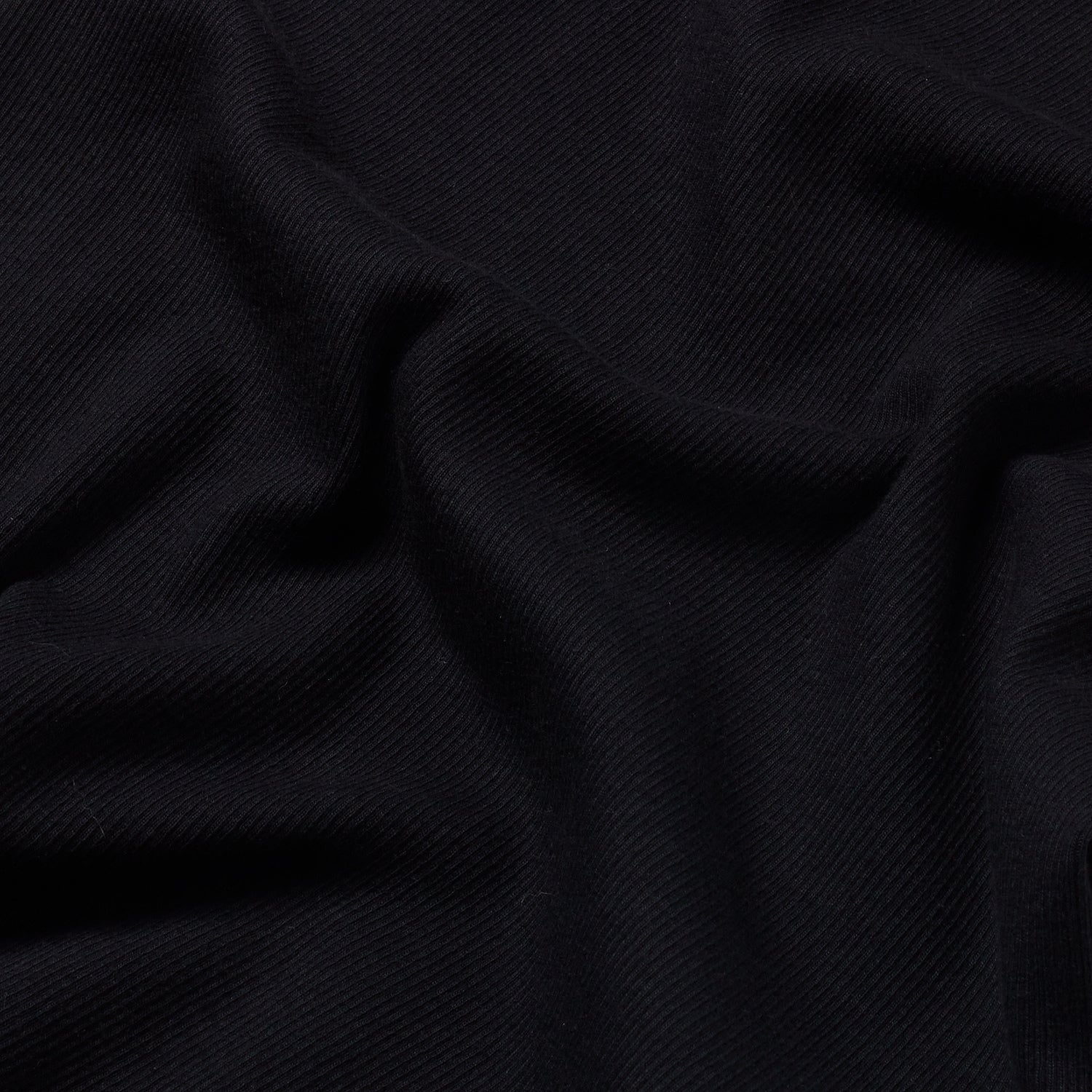 Close-up of the black tank top’s fabric, highlighting the fine ribbed texture and quality craftsmanship.